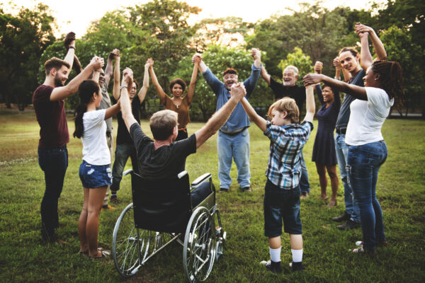 Group of people holding hand together in the park Group of people holding hand together in the park